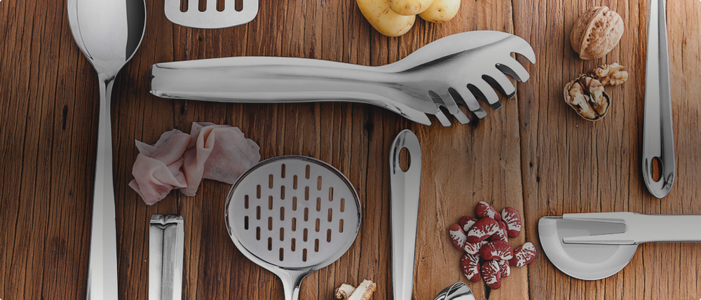 Table with stainless steel kitchen utensils.