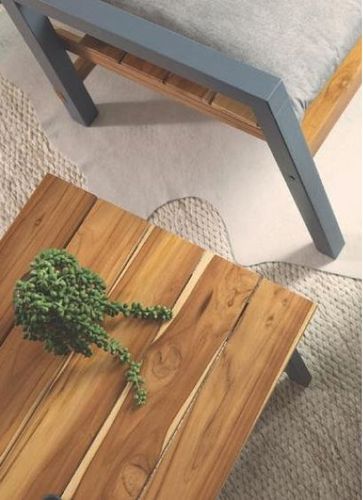 Wooden table with a plant on it.